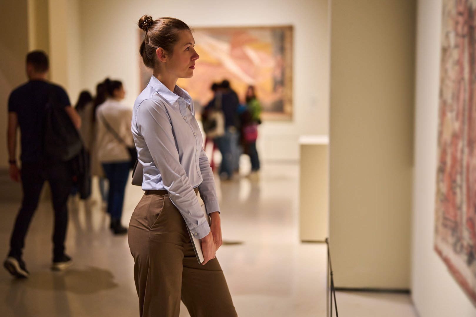 Visitor in historical museum looking at art object