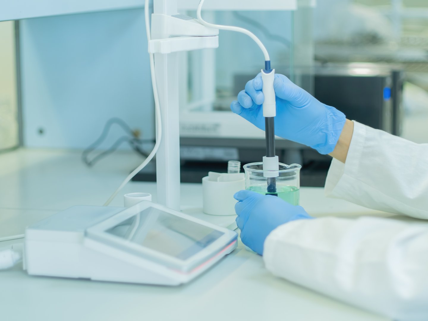 The scientist work at the chemical solution with pH meter