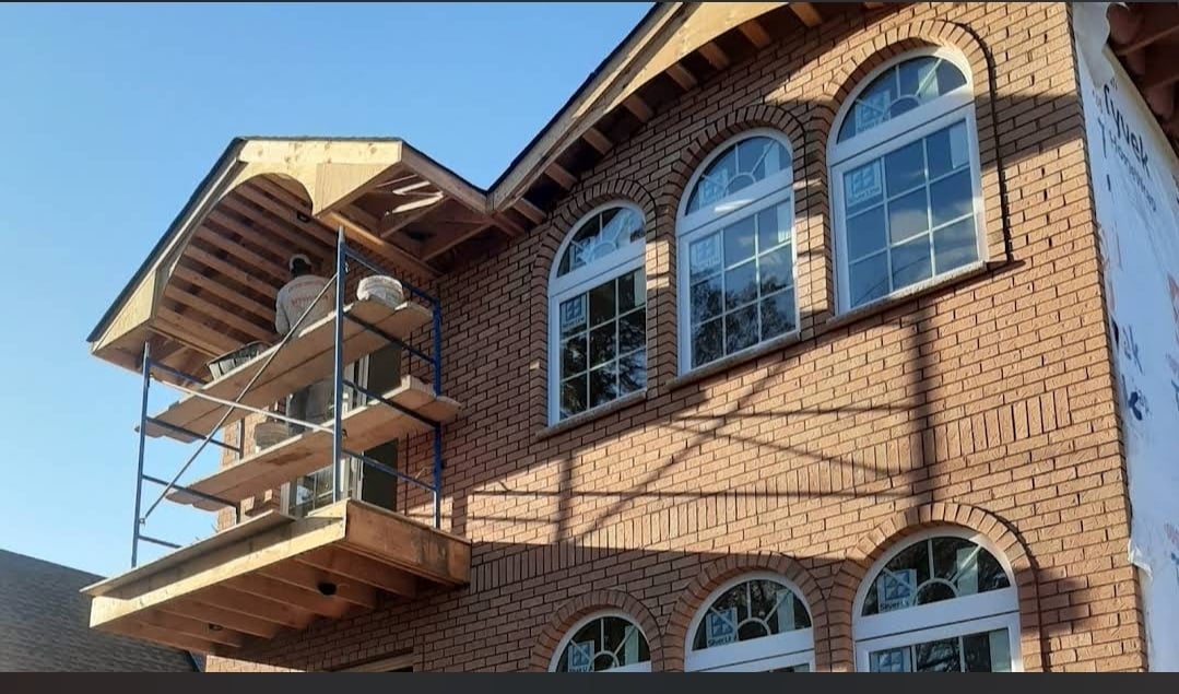 Plastic soffits mounted to roof rafters on house with cathedral ceiling