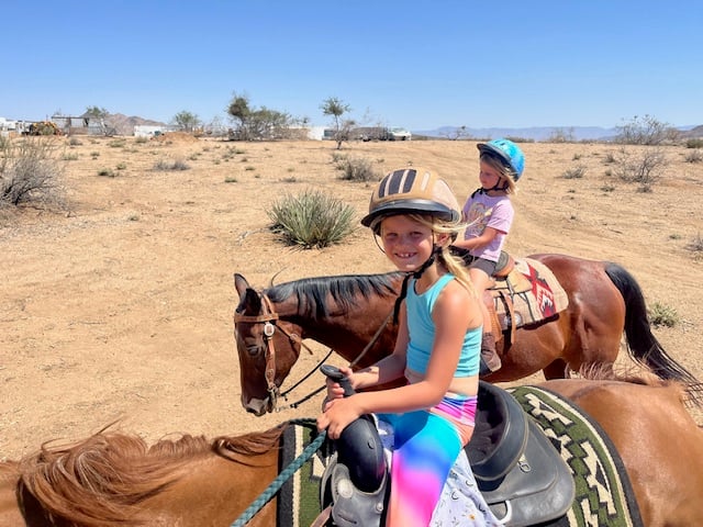 Rising Hope Farms - Horse and rider in natural farm setting