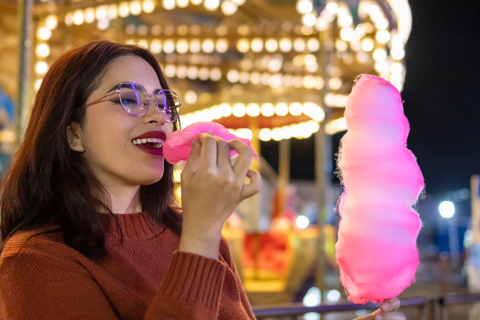 Happy woman with candyfloss at the fair