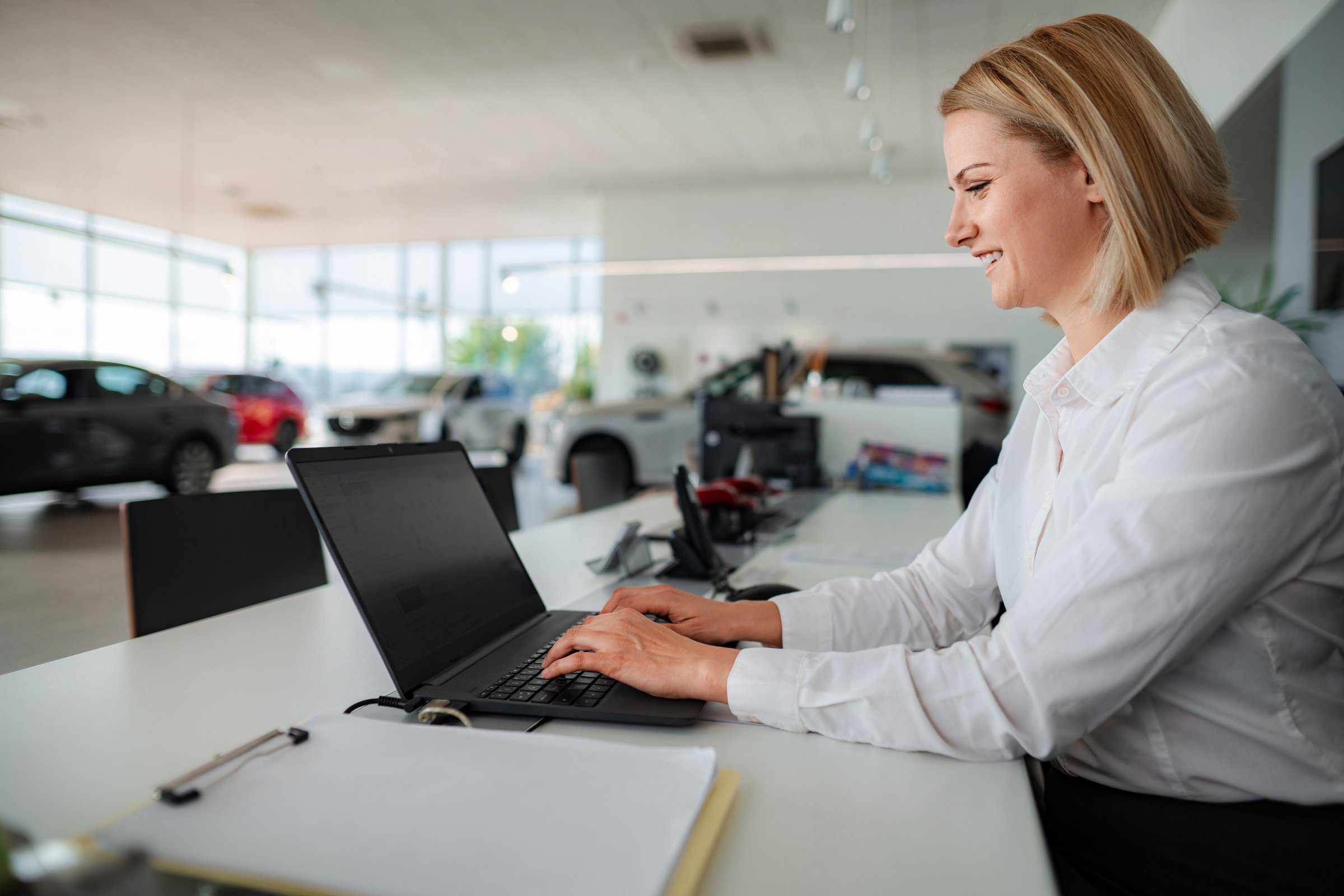 Woman sales manager in car dealership office