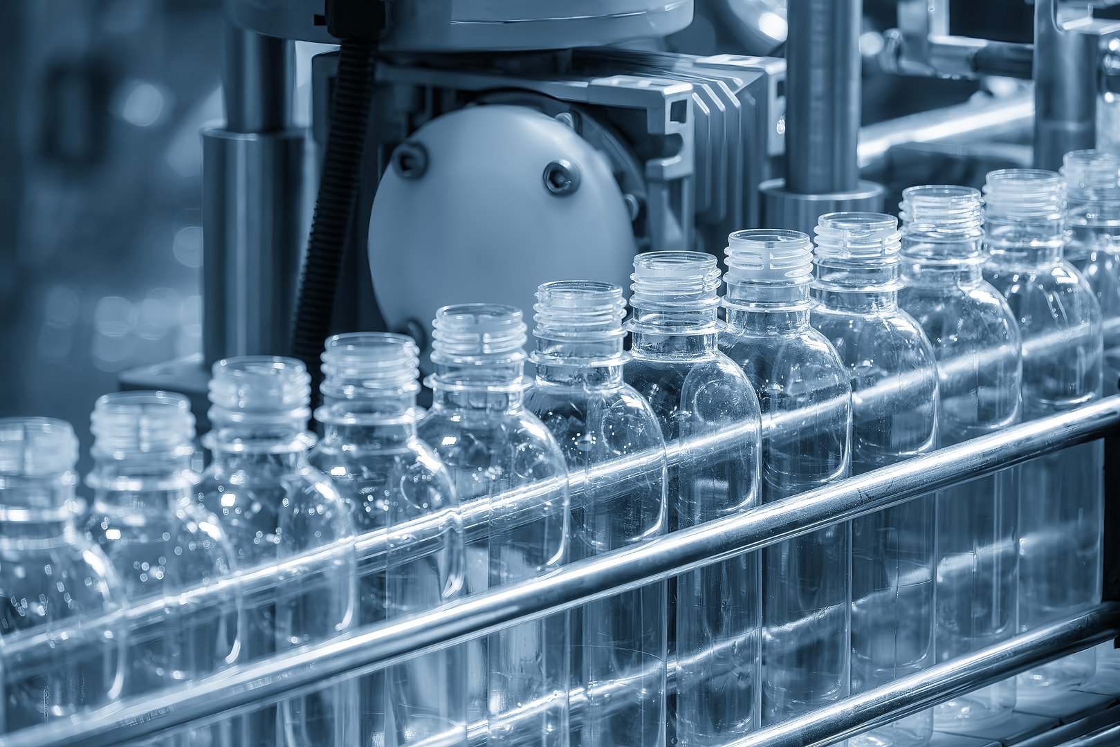 The hi-technology of drinking water manufacturing process. The  empty drinking water bottles  on the conveyor belt for filling process.