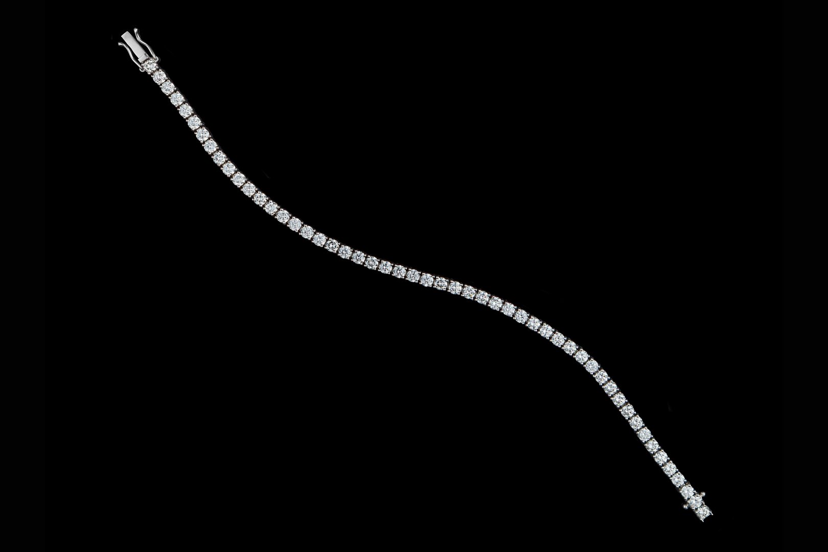 bracelet silver, gold with stone diamonds on black background close-up