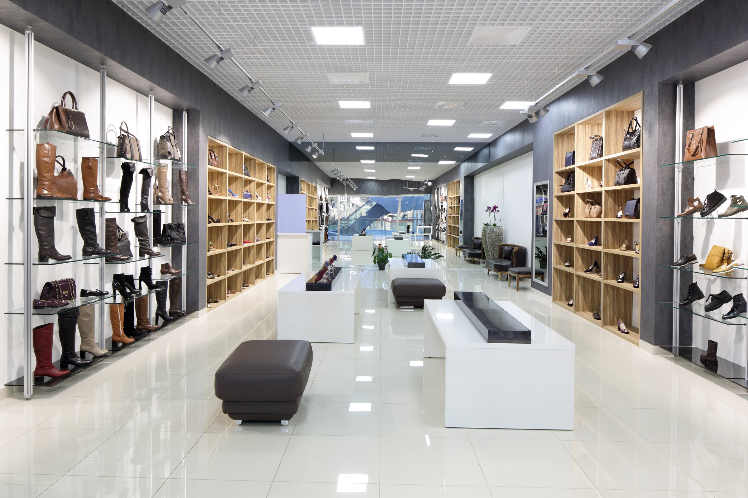 bright and fashionable interior of shoe store in modern mall