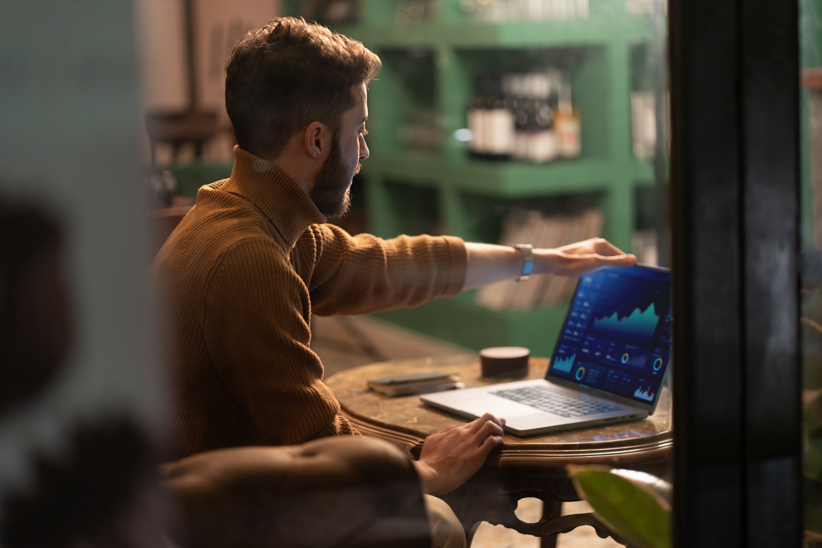 Digital nomad working with technology and data in modern cafe environment