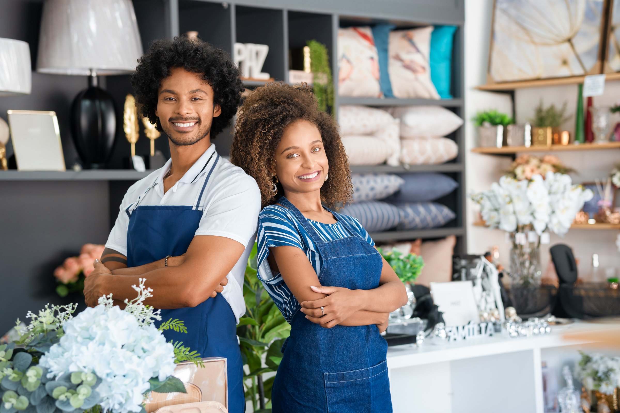 Entrepreneurial couple poses for a portrait in a neighborhood business