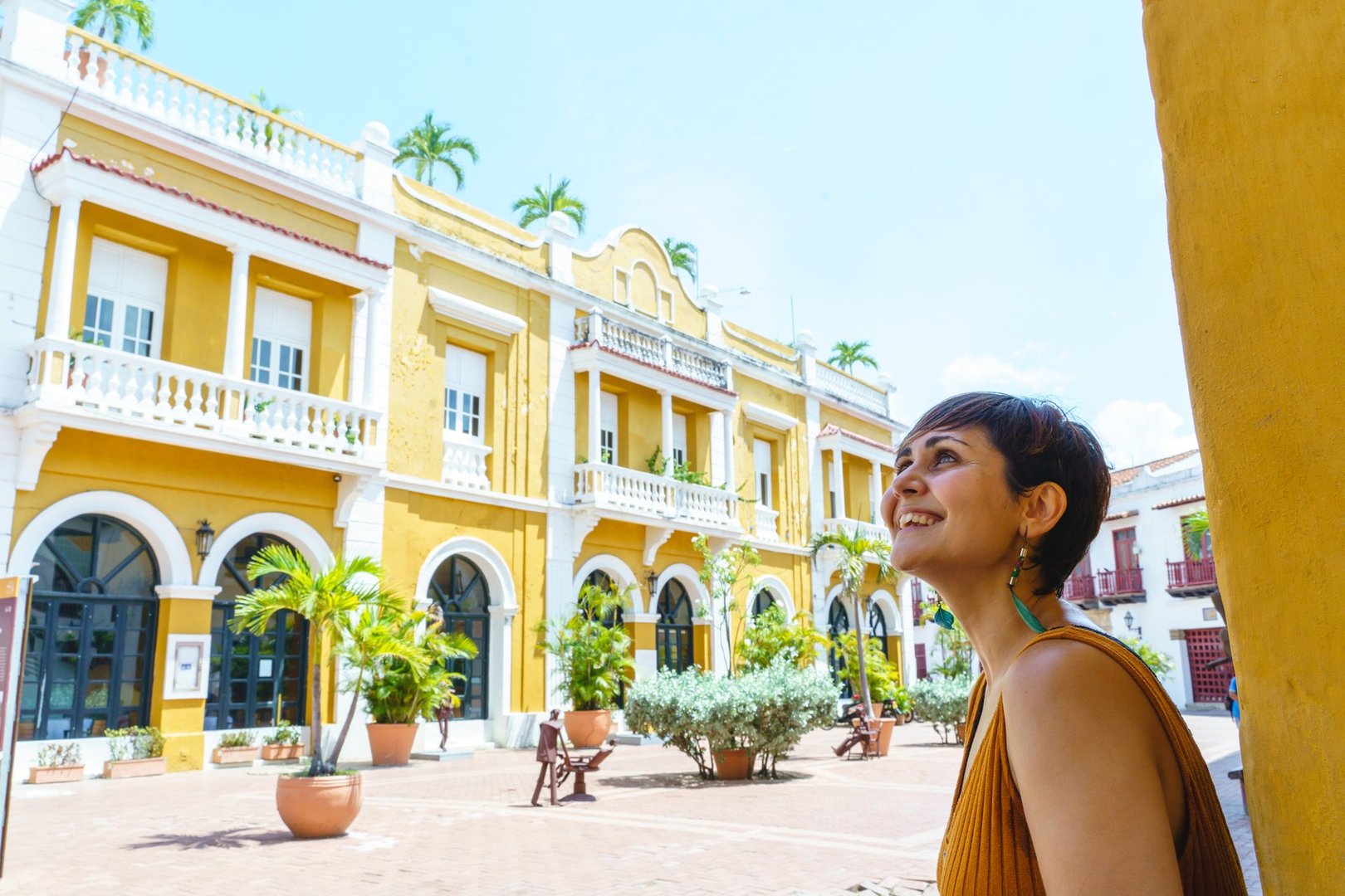 Horizontal view of latin woman sightseeing in spanish historic ancient city. Travel to Colombia concept.