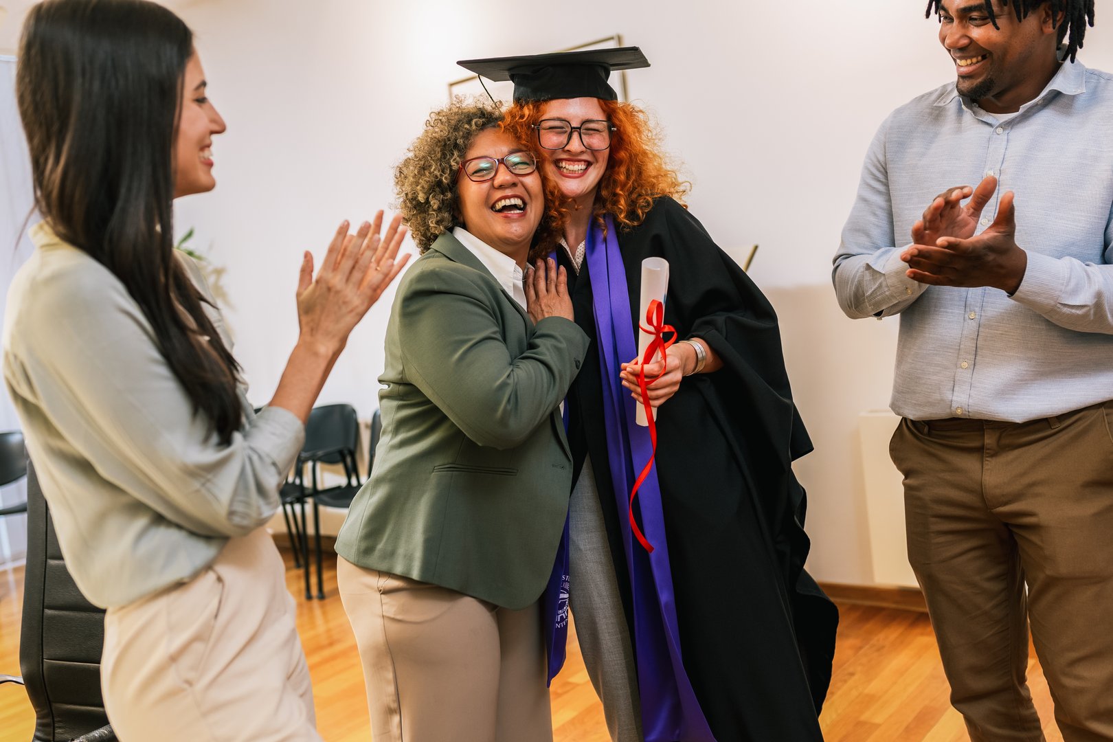 Ginger graduate student celebrating graduation in toga with her family.