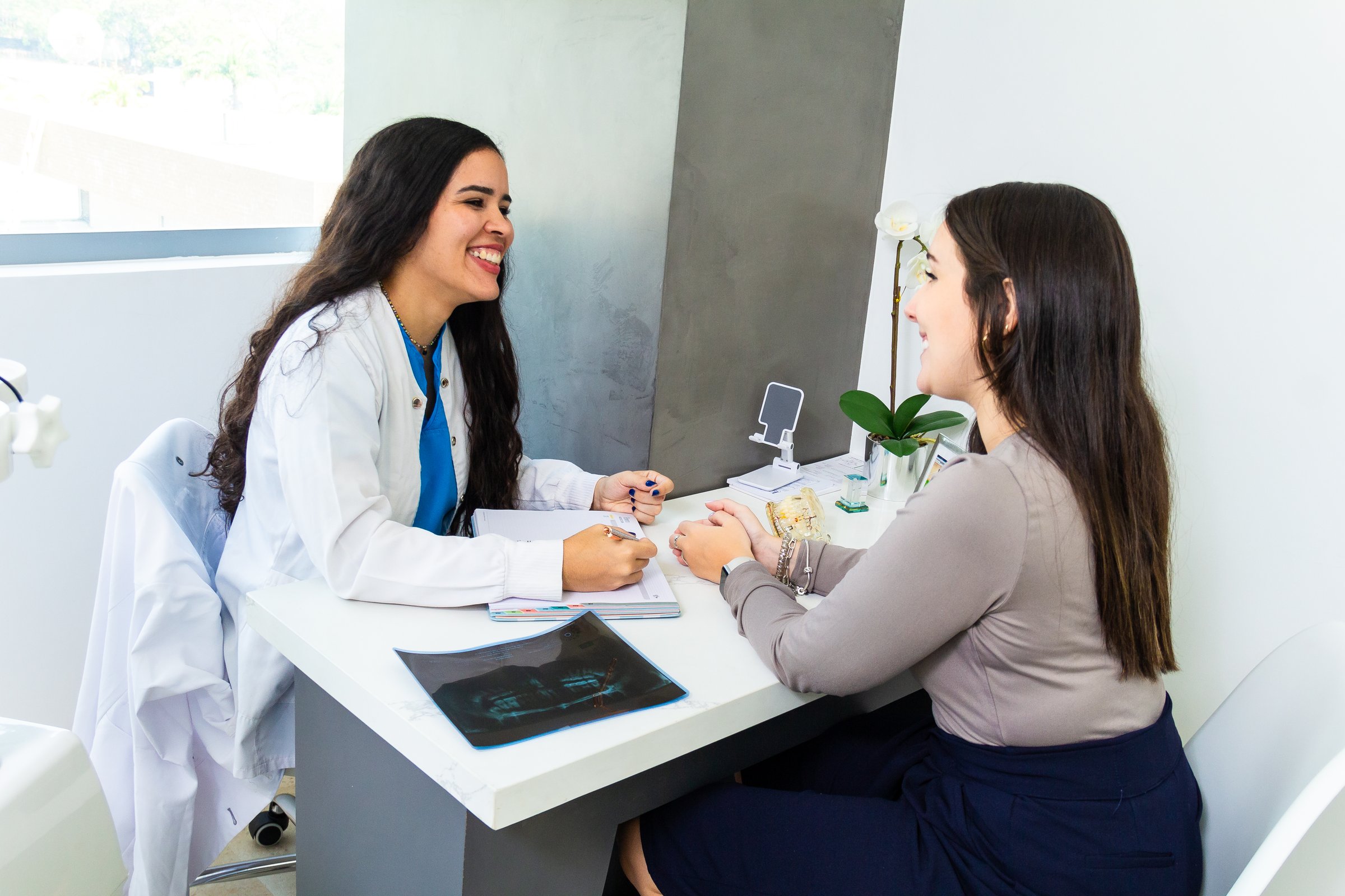 Adult patient discussing Invisalign vs braces for adults with a dentist at South Tweed Dental