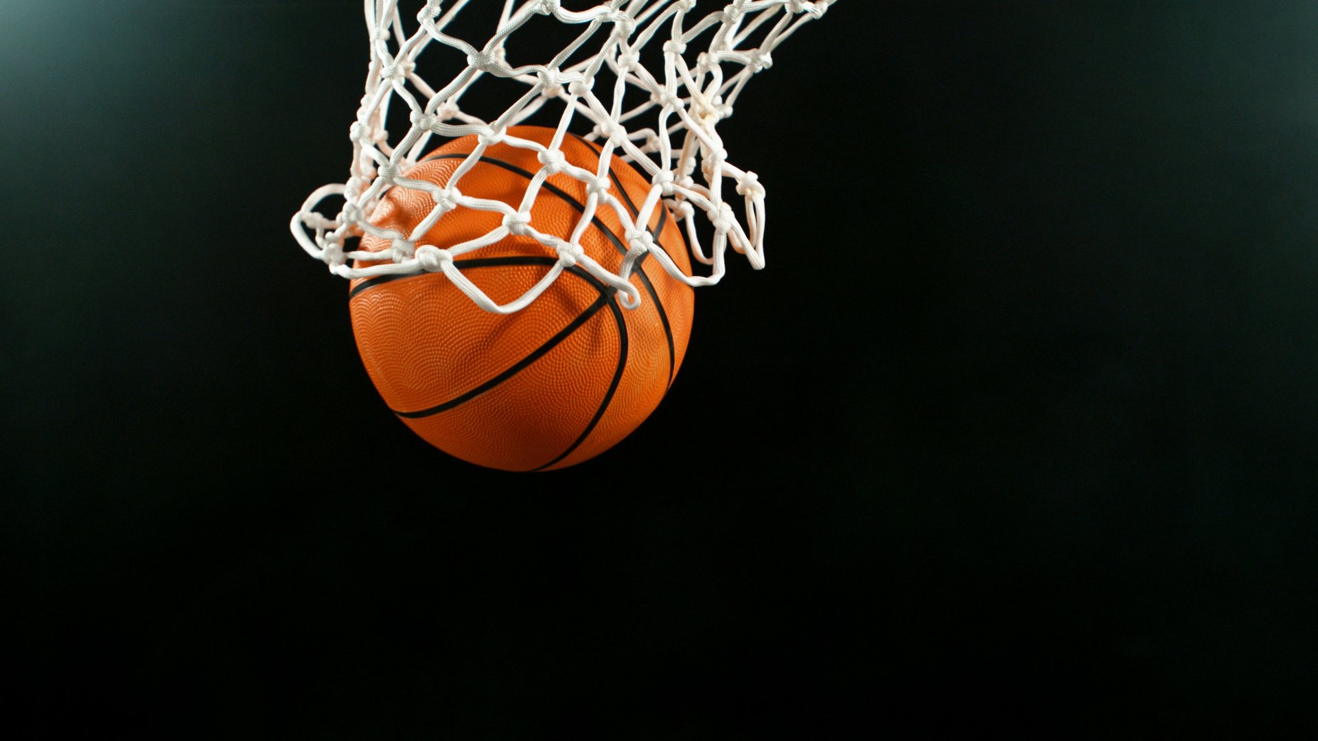 Detail of basketball ball hitting the hoop, top view