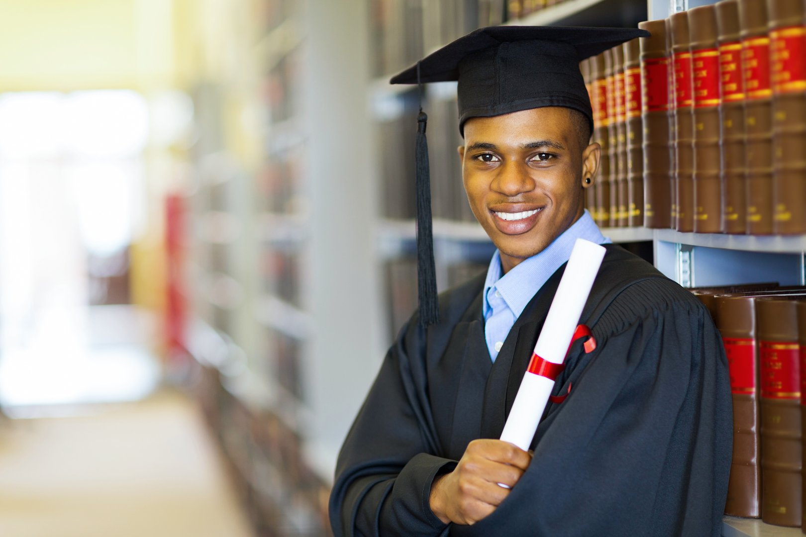 happy african american law school graduate on graduation day