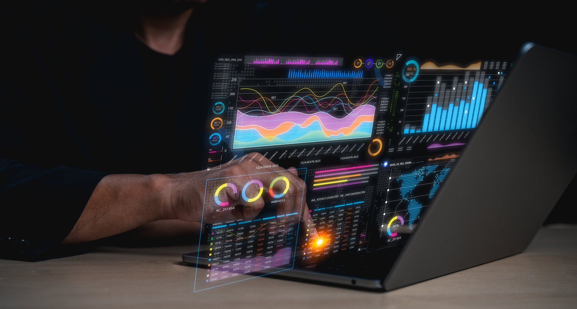 A person interacts with a laptop displaying floating digital data charts and graphs, symbolizing advanced data analysis and technology.