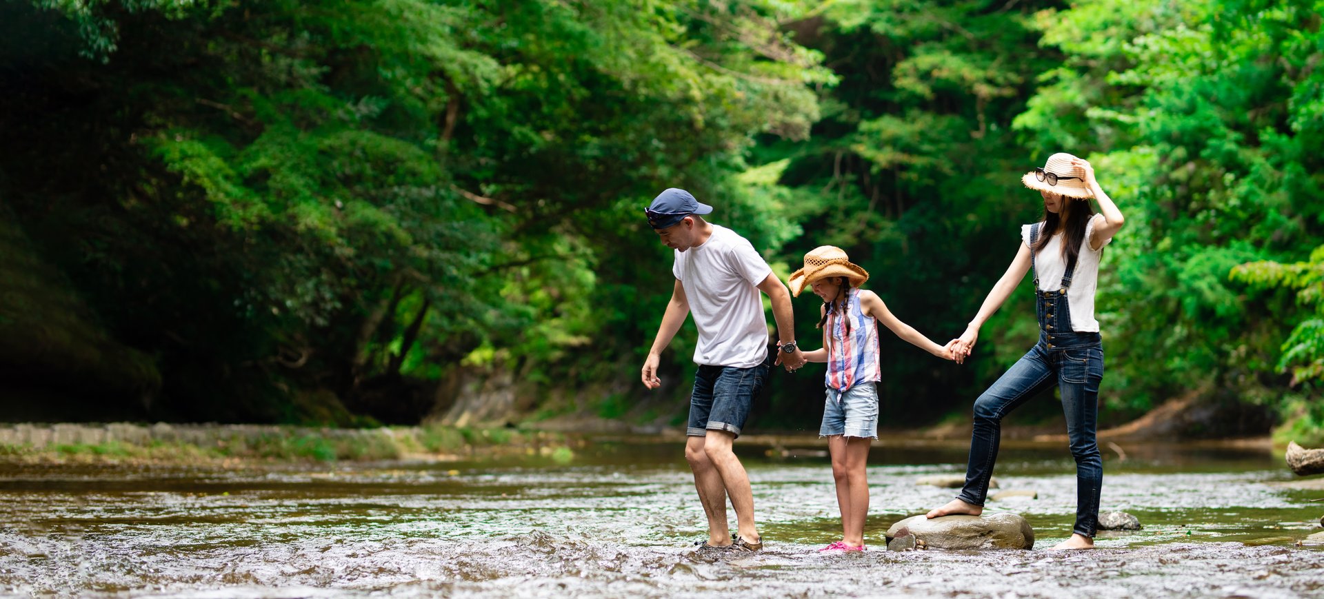 Mother and daughter sitting and chatting together in a mountain stream