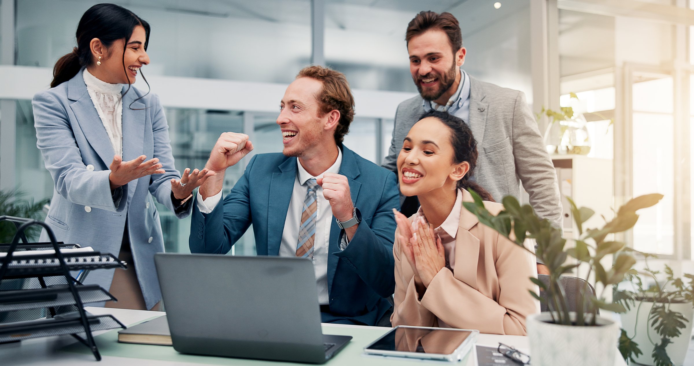 Fist pump, celebrate and business people on laptop in office with good news, success and victory. Corporate, team and men and women on computer applause for feedback, financial growth and investment