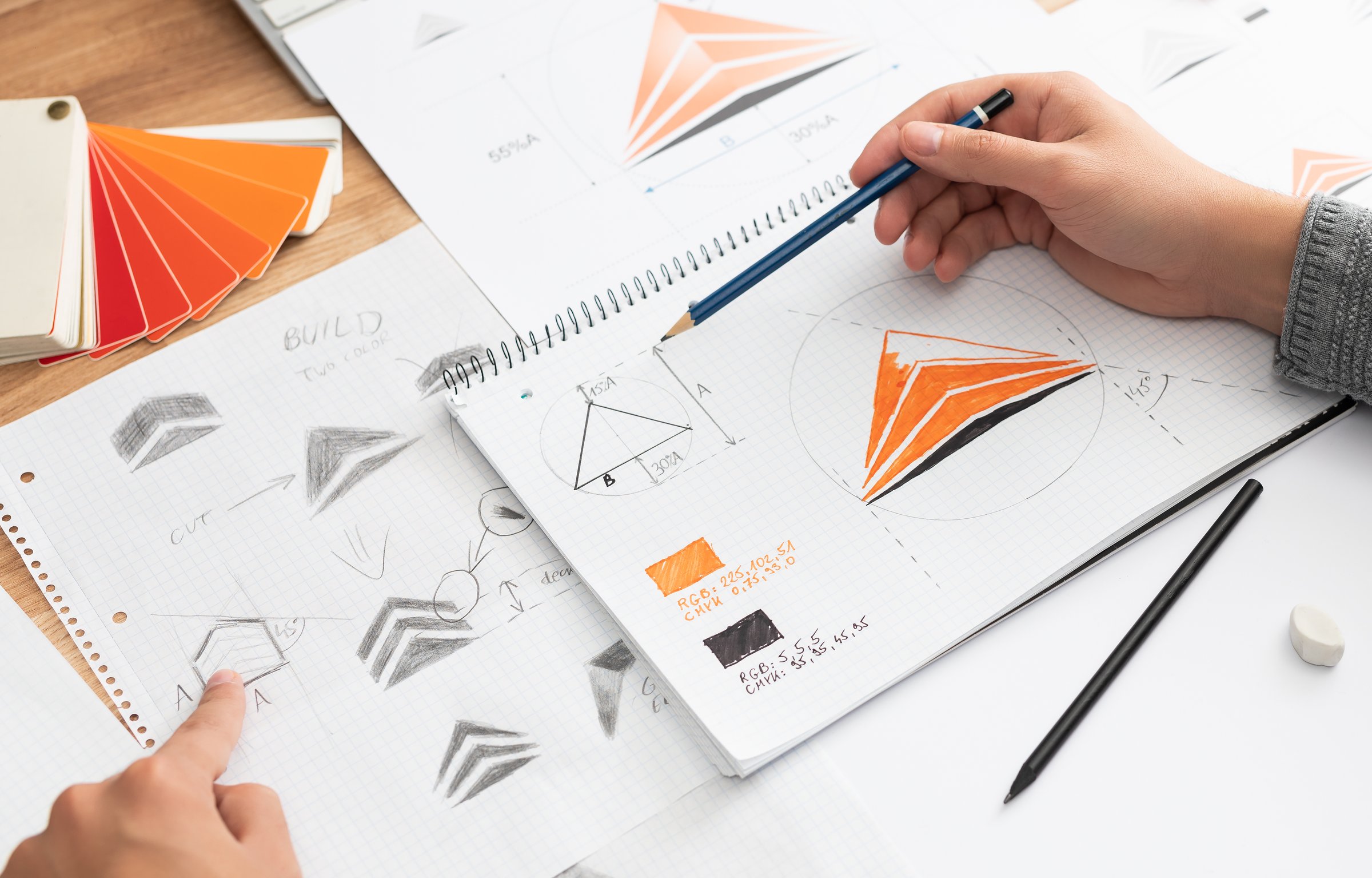 Graphic designer drawing sketches logo design. The concept of a new brand. Professional creative occupation with idea.