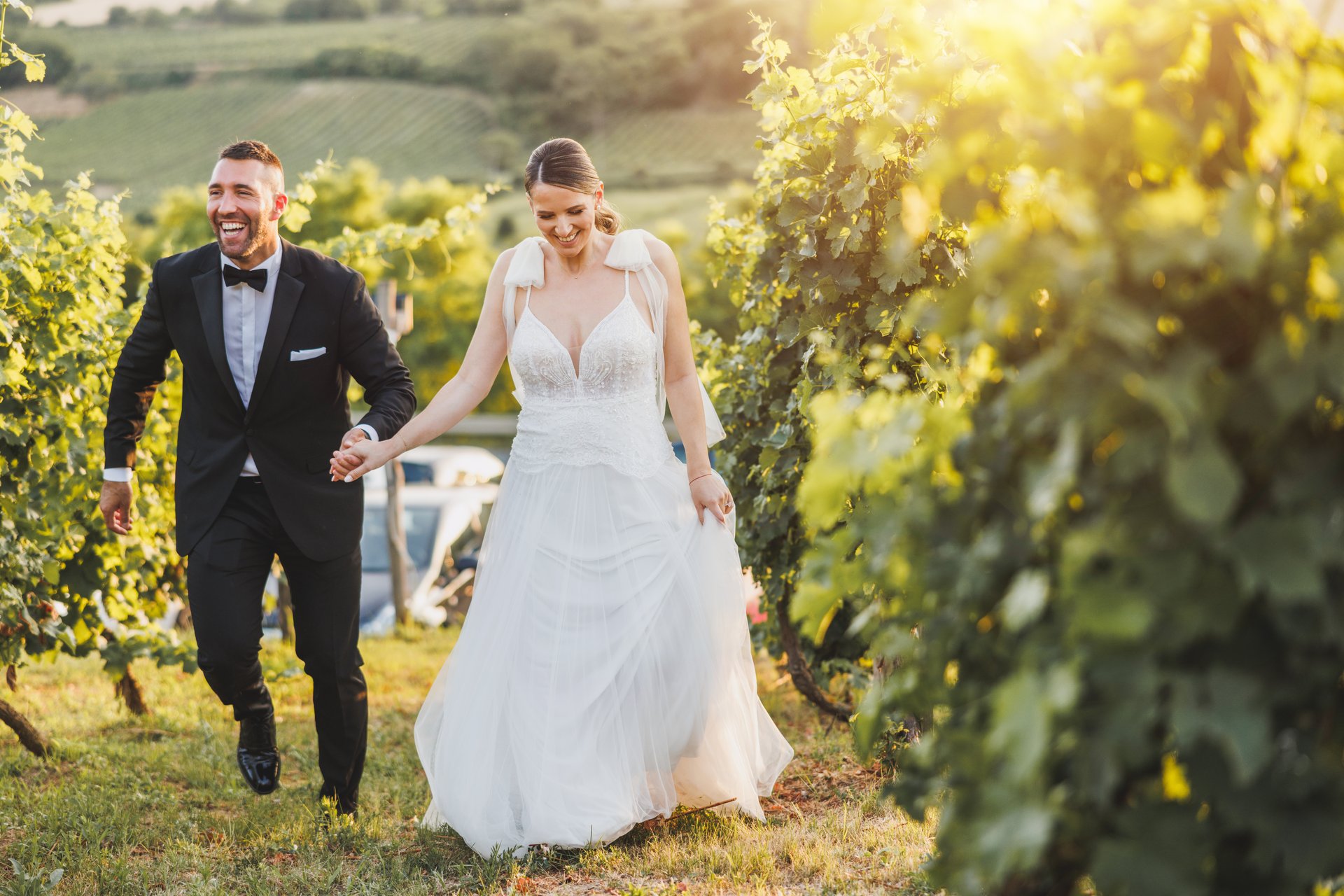 Shot of a happy young couple having fun in vineyard at sunset on their wedding day.