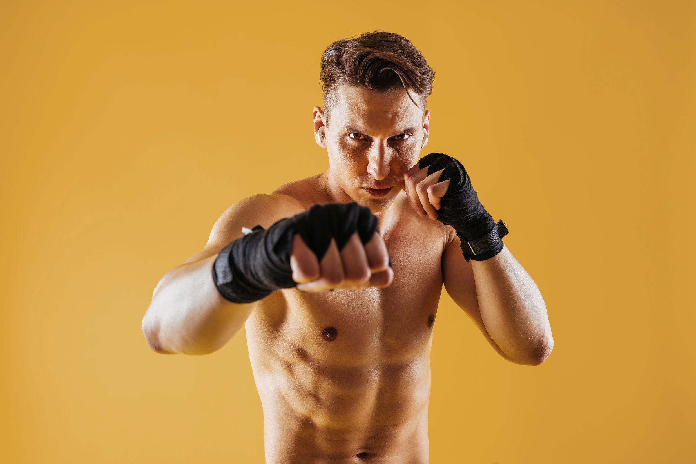 Athletic man with fit muscular body training in studio - Active man doing a workout, colorful lighting and background, concepts about fitness, sport and health lifestyle
