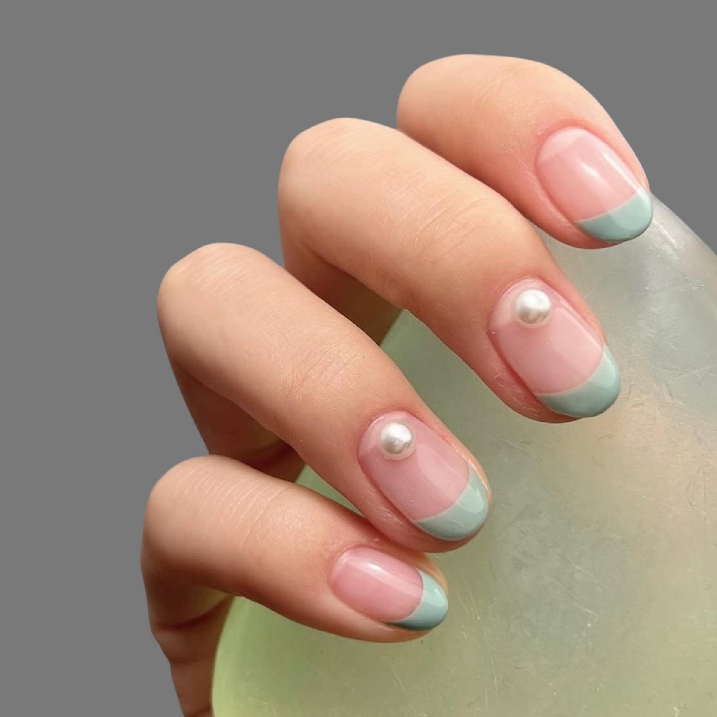 Female hand with modern and elegant innovative hand drawn nail manicure design with modern shape and light background