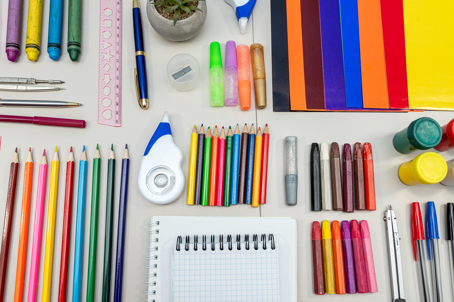 The table is meticulously arranged featuring a diverse selection of essential school supplies that aim to effectively meet students various educational needs