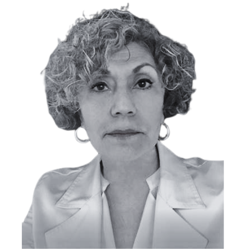 Black and white portrait of a person with curly hair, wearing a light-colored blazer and hoop earrings, looking at the camera.