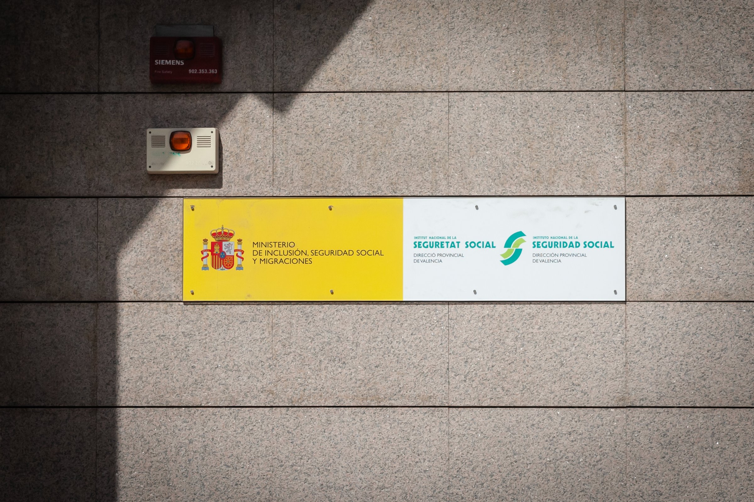 Valencia, Spain - October 13, 2024: The photograph features the official signs of the Ministerio de Inclusión, Seguridad Social y Migraciones (Ministry of Inclusion, Social Security, and Migrations) and the Instituto Nacional de la Seguridad Social (National Institute of Social Security) affixed to a government building in Valencia, Spain. These institutions are key components of Spain's welfare state, responsible for administering social security benefits, healthcare services, and policies related to inclusion and migration. The image underscores the role of public administration in providing essential services to citizens, including pensions, unemployment benefits, and healthcare coverage. The display of these signs signifies transparency and accessibility of government services to the public. Themes associated with this image include government infrastructure, social welfare systems, public health administration, and the functioning of Spain's welfare state mechanisms. The photograph highlights the importance of these institutions in maintaining social protection and supporting the well-being of residents. It also reflects the administrative aspects of governance and the physical presence of government agencies within urban environments, contributing to the overall structure of public service delivery in Spain.