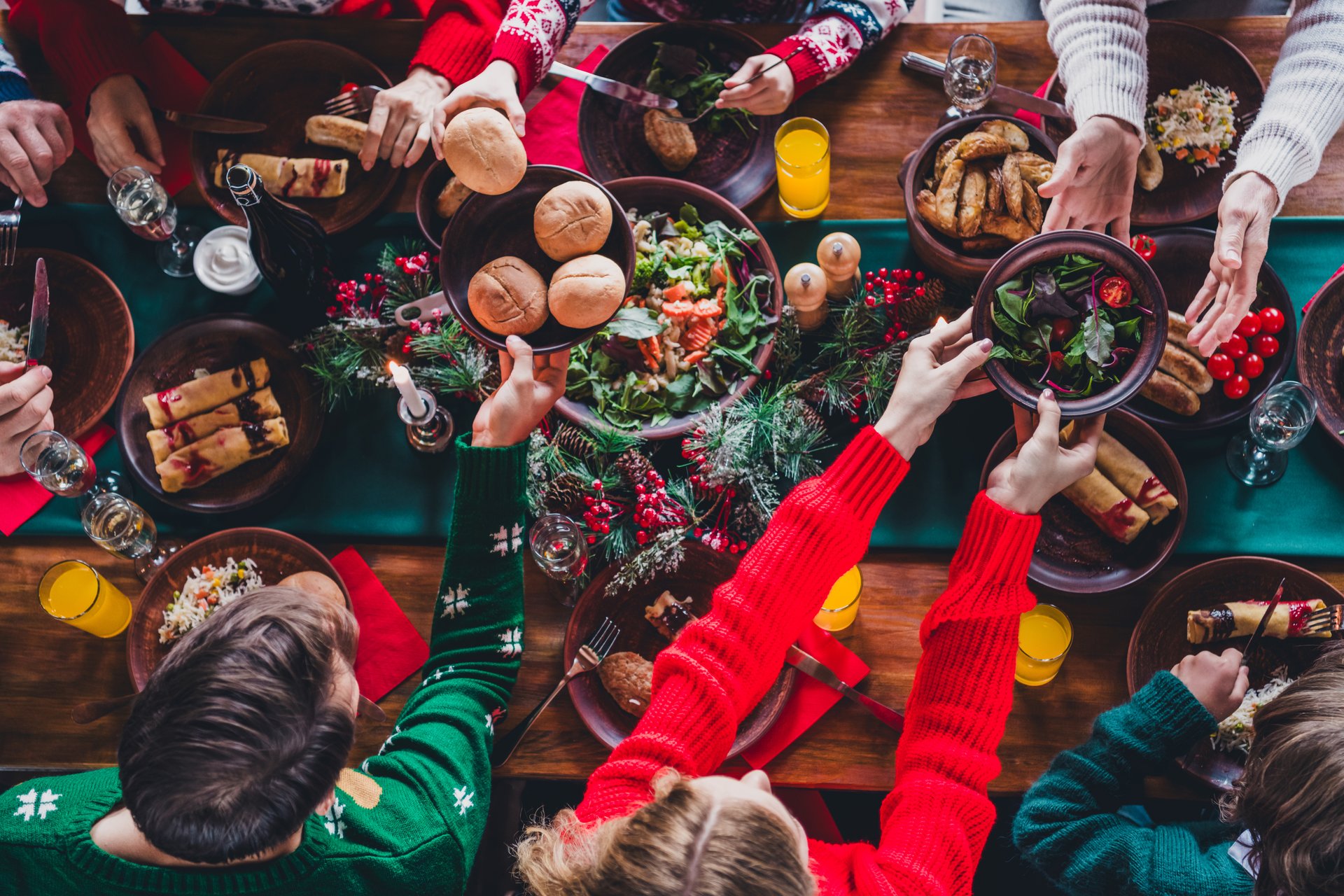 High angle view cropped photo of group family members eat food table gather celebrate christmas apartment indoors.