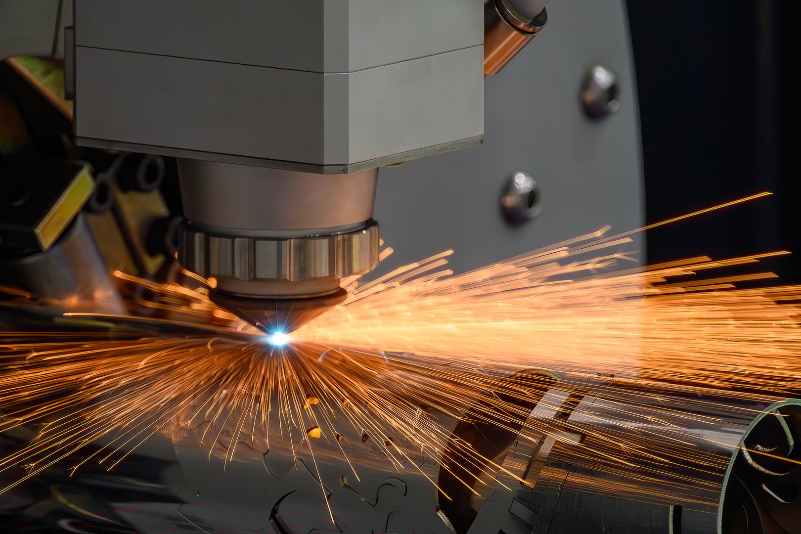 Close up scene the fiber laser cutting machine cut the stainless steel tube and sparkling light. The hi-technology sheet metal manufacturing process by laser cutting machine.