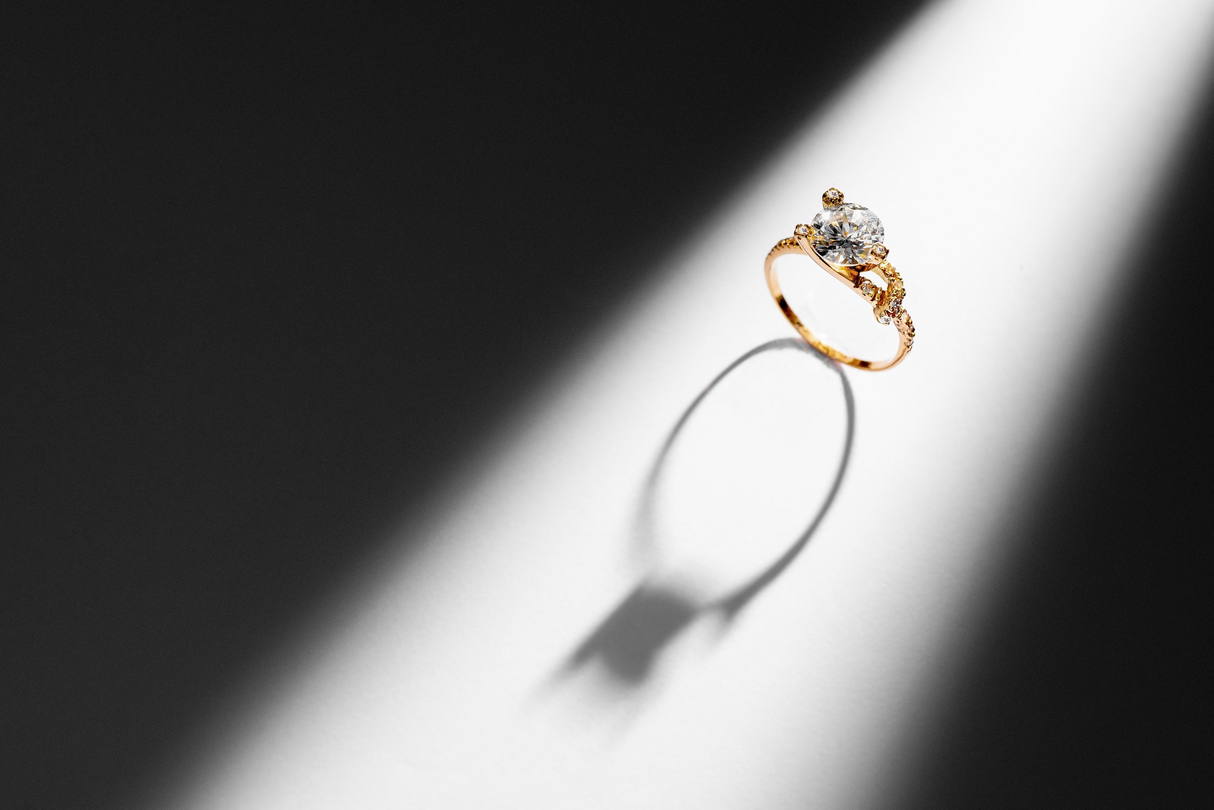 Elegant gold diamond ring on black and white background