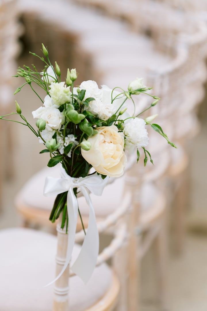 Elegant close-up of a wedding chair adorned with romantic floral decoration