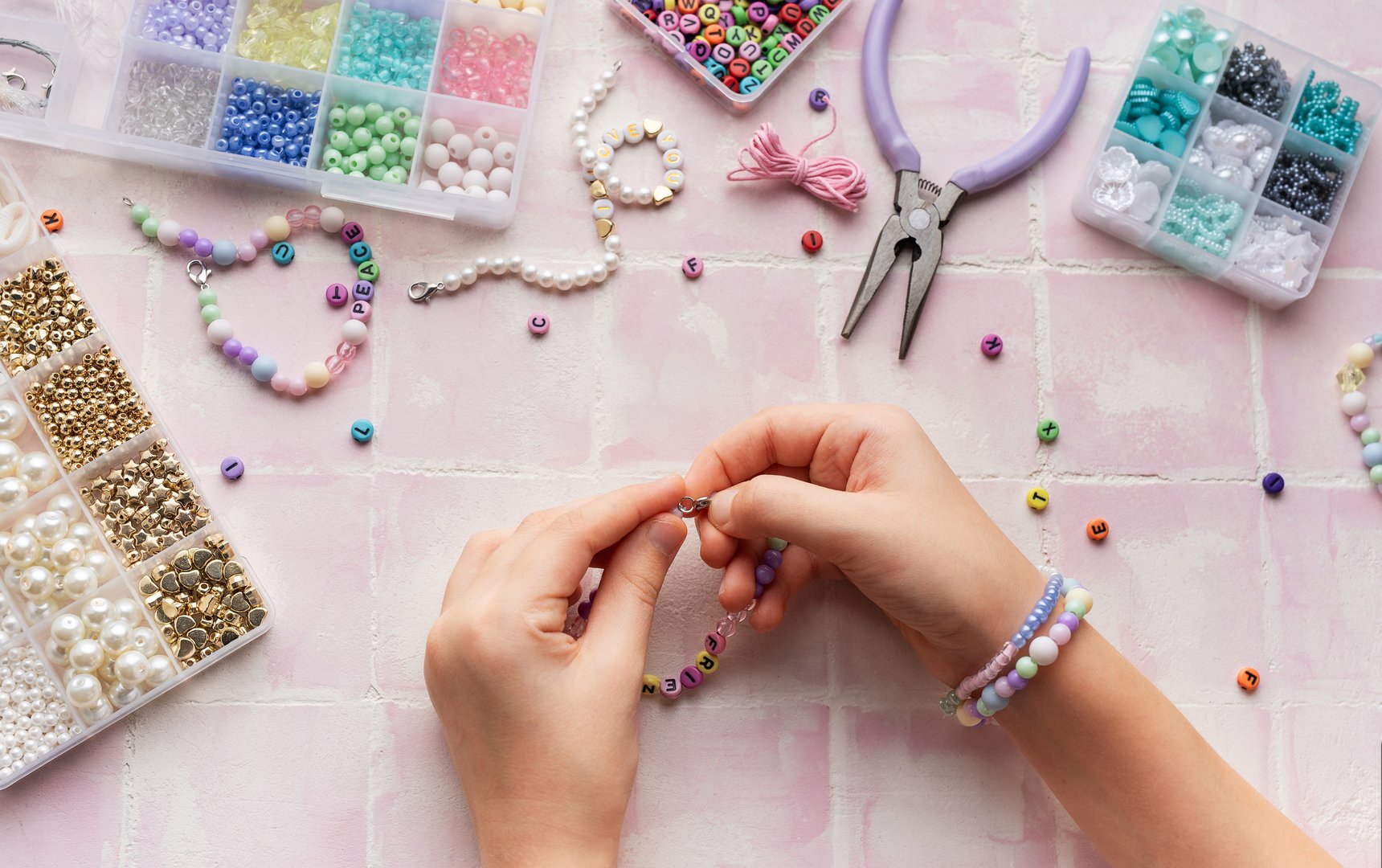 Kid creating handmade jewelry, enjoying a relaxing hobby