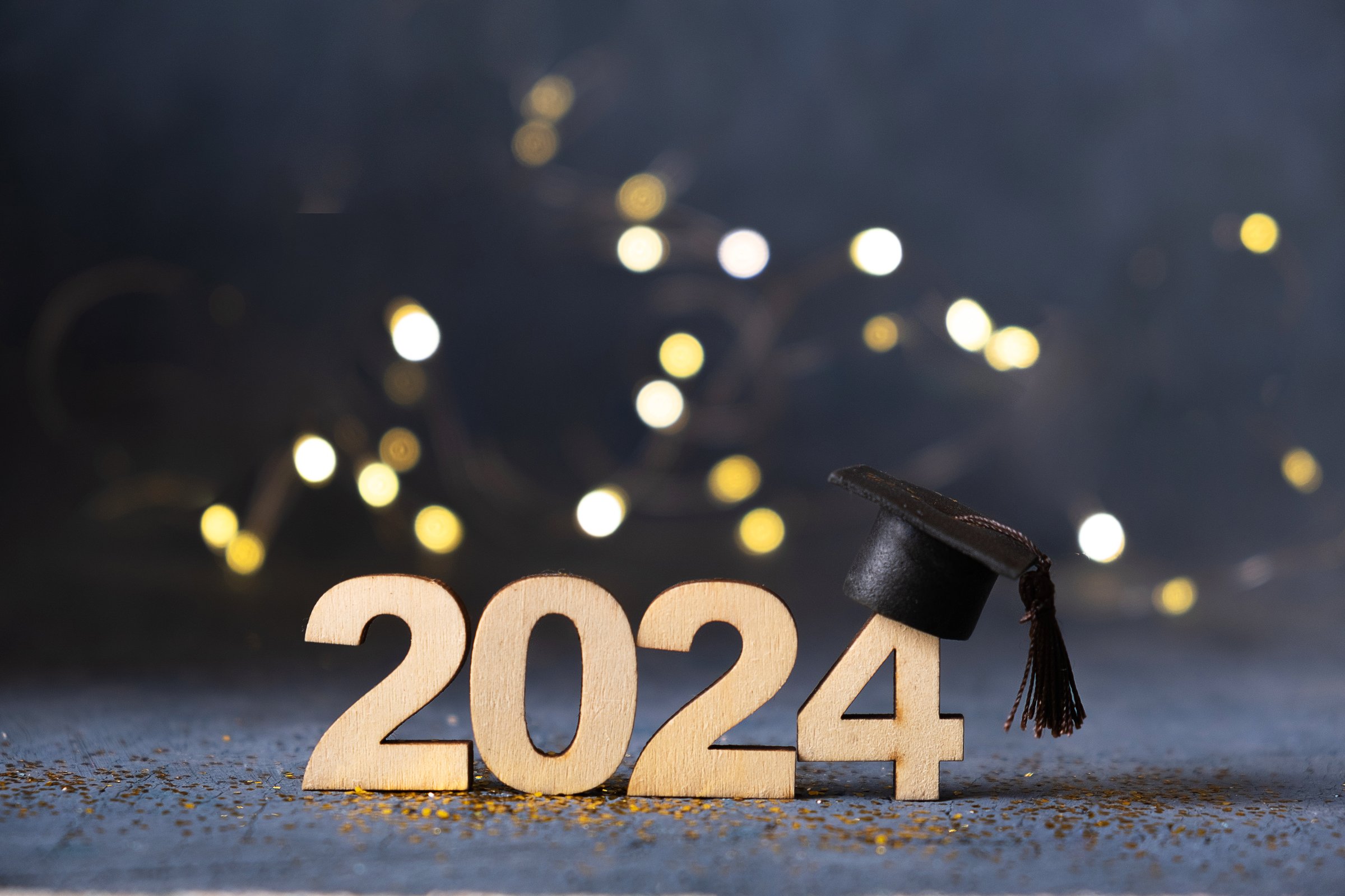 Class of 2024 concept. Number 2024 with graduated cap and bokeh lights