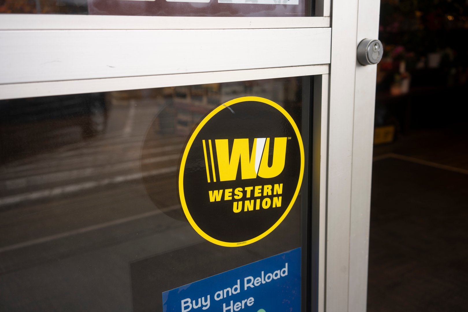The Western Union sticker is seen at the entrance to one of its agent locations in a grocery store in Lake Oswego