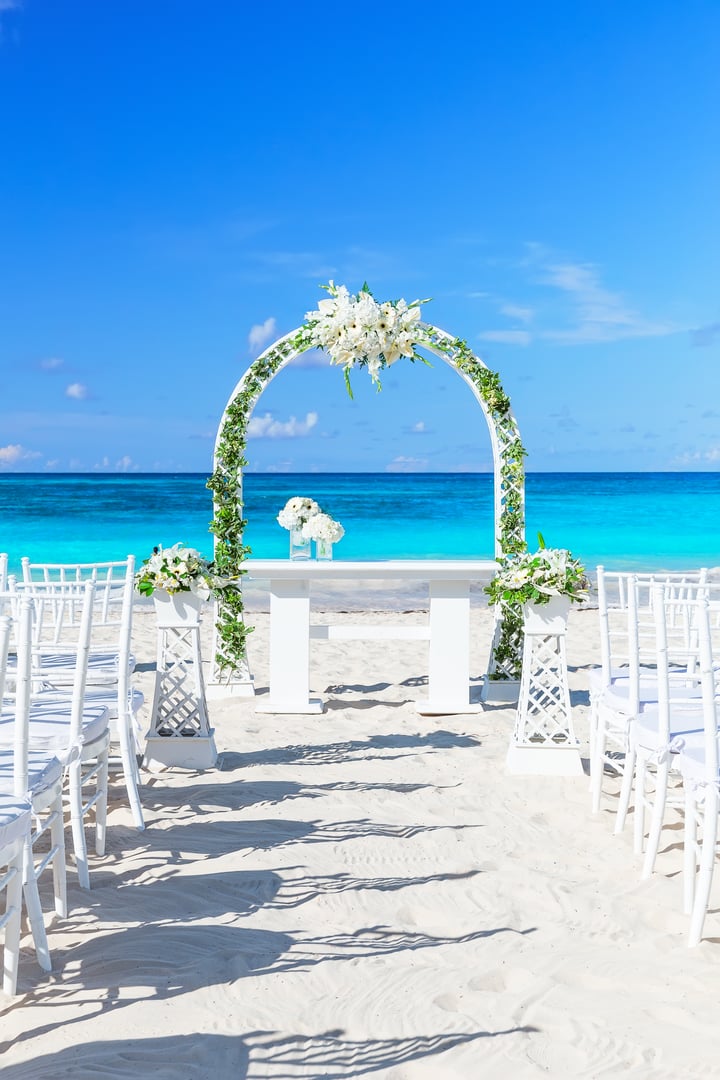 Tropical paradise  wedding setting and beautiful wedding arch on the beach in Punta Cana, Dominican Republic.