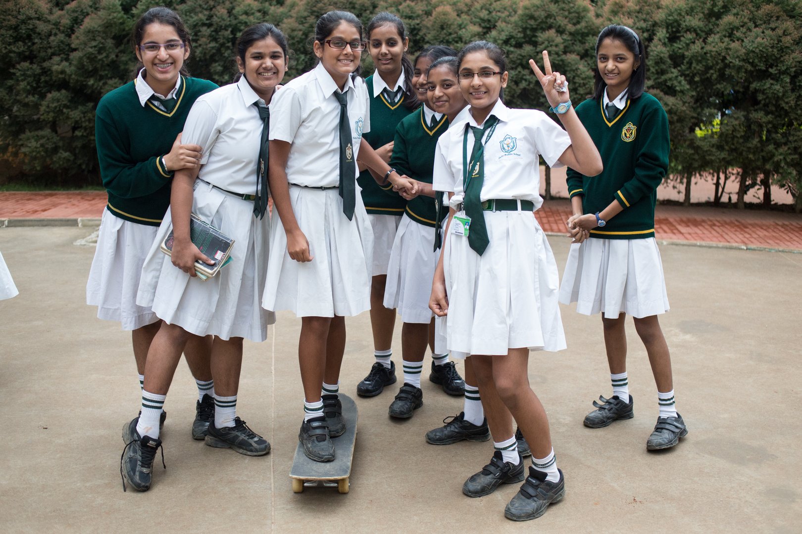A group of schoolgirls trying skateboarding at a afternoon skate demonstration in Bangalore, India