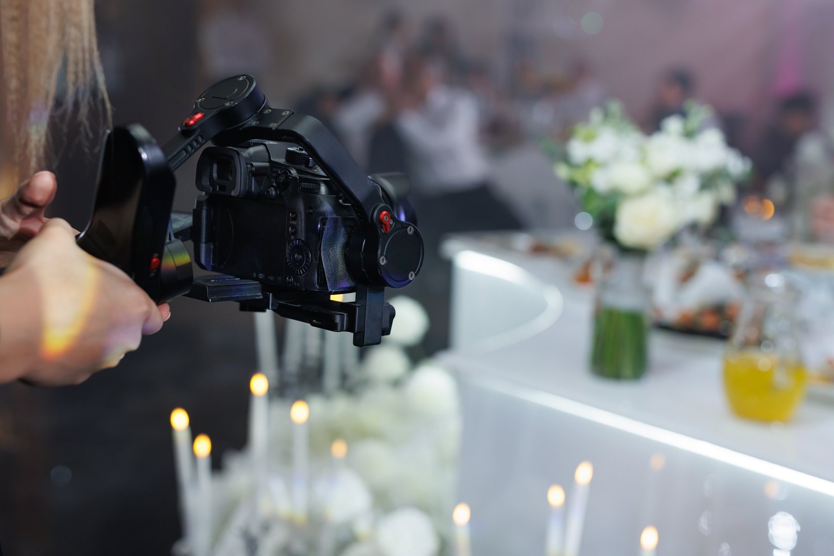Cameraman filming a wedding reception with a professional video camera
