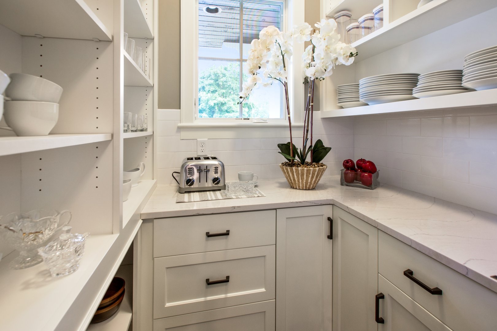 White cabinets and shelves with white plates and bowls
