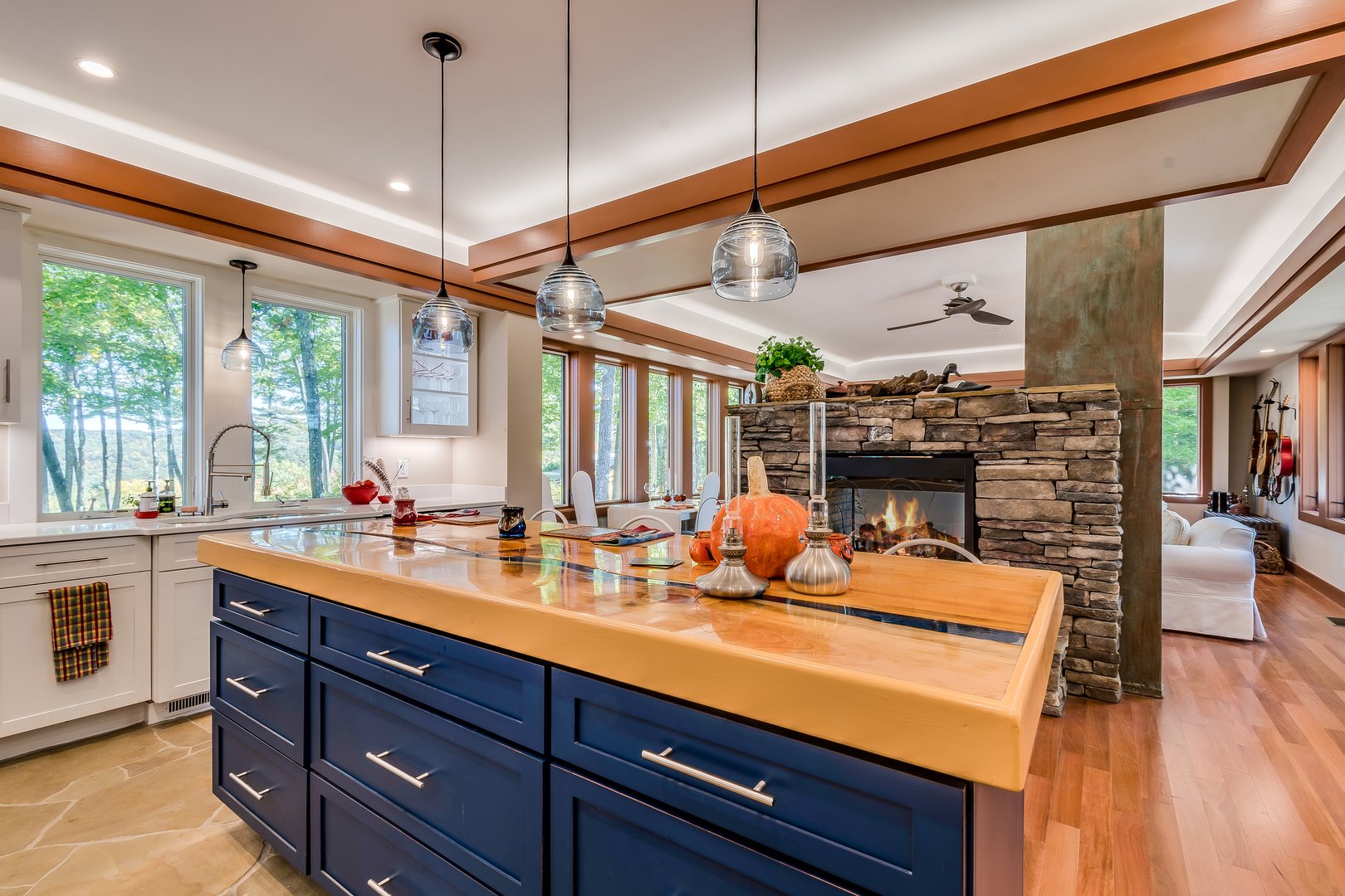 Lots of colors in new kitchen with three pendant lights hanging over the island