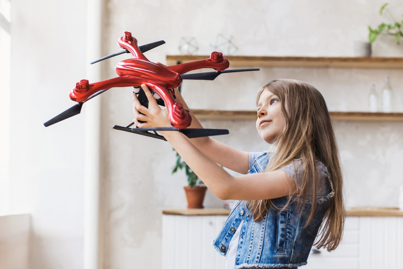Young cute girl exploring quadcopter. Education, future, children, technology, science and modern people concept