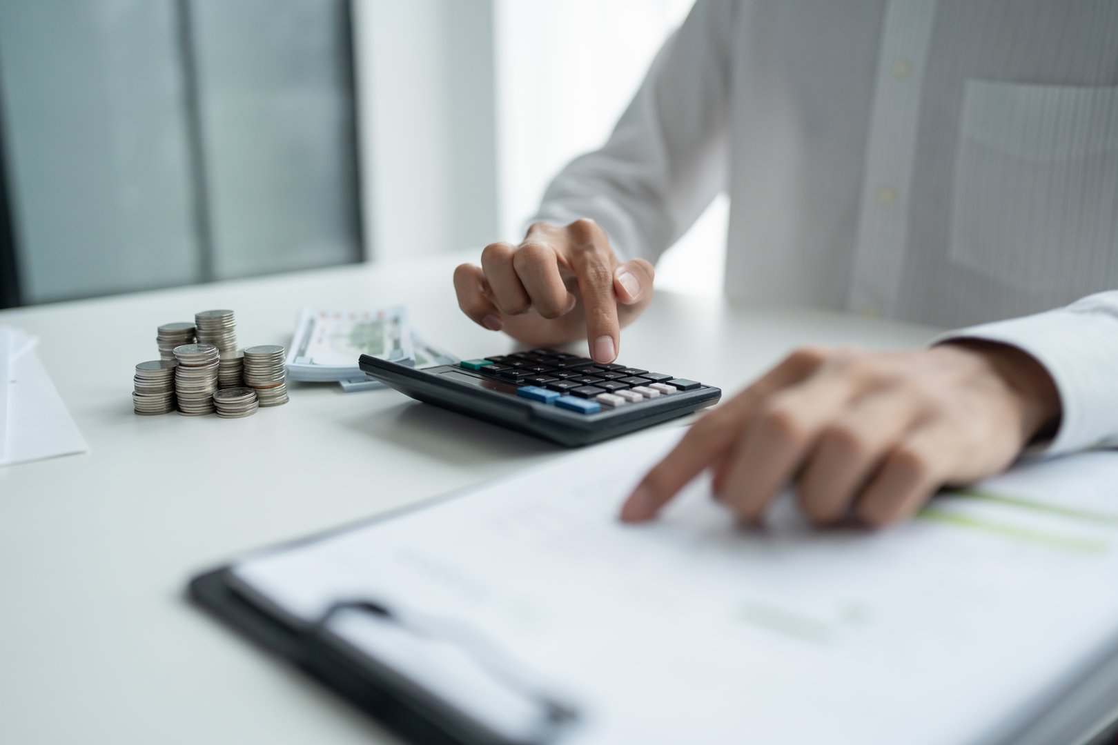 Businessman checking bills taxes bank account balance and calculating annual financial statements of company. Accounting Audit Concept.