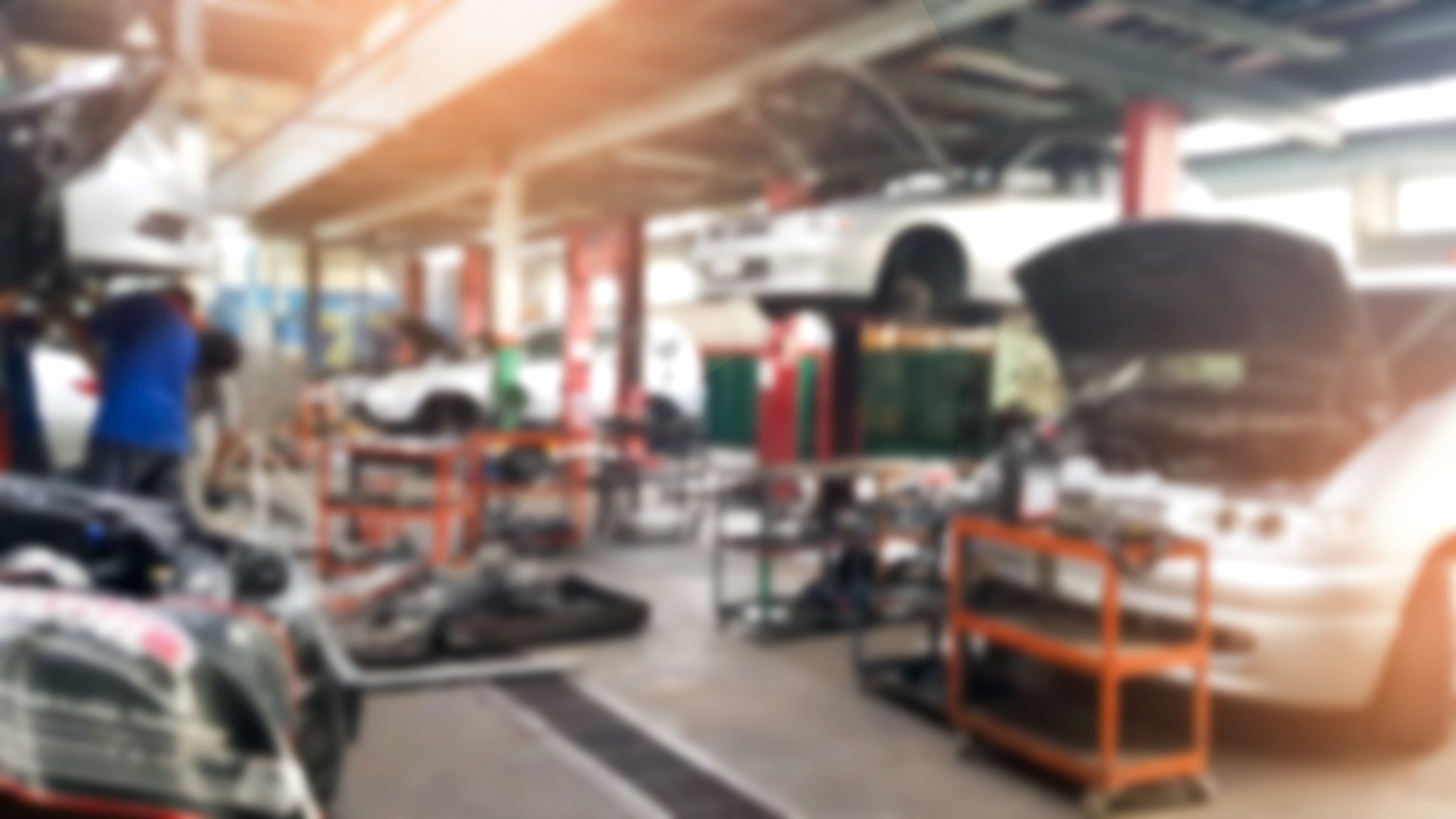 Abstract blur car technicians repairing cars in workshop service station background.Auto repair shop in bokeh, defocused background