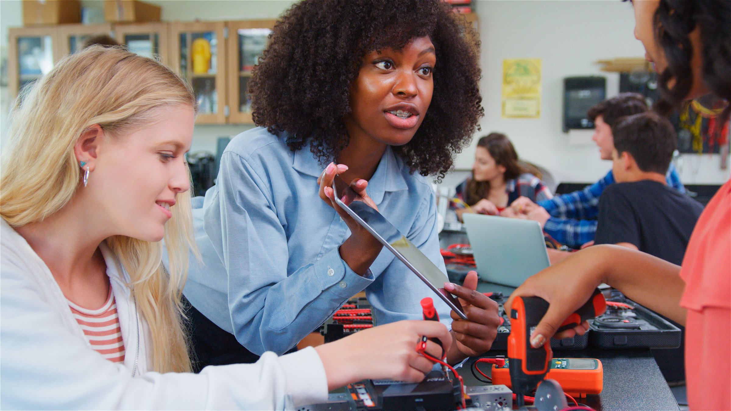 High School College Or University Teacher With Female Pupils Make Robotic Vehicle In Science Lesson