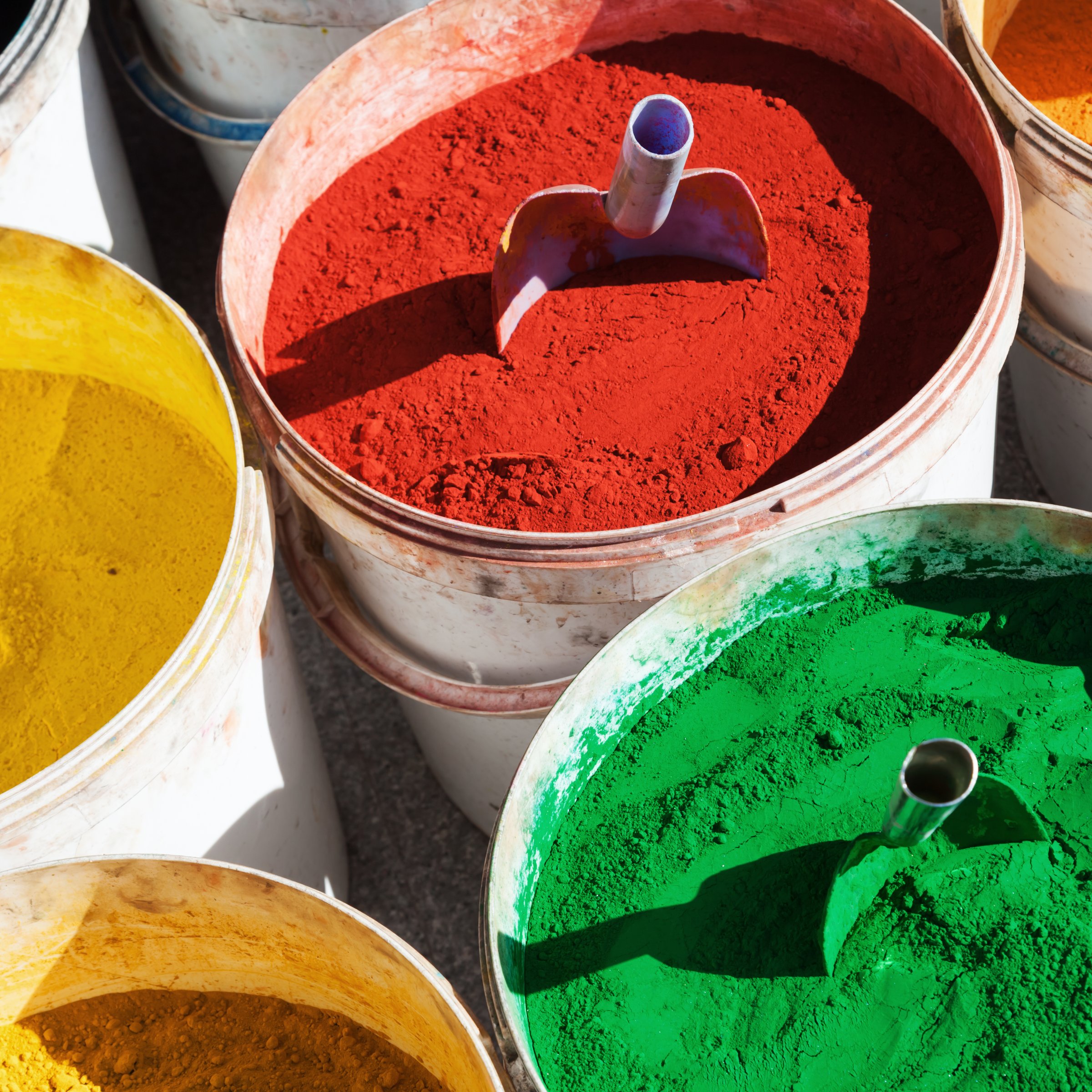 different color powder in buckets