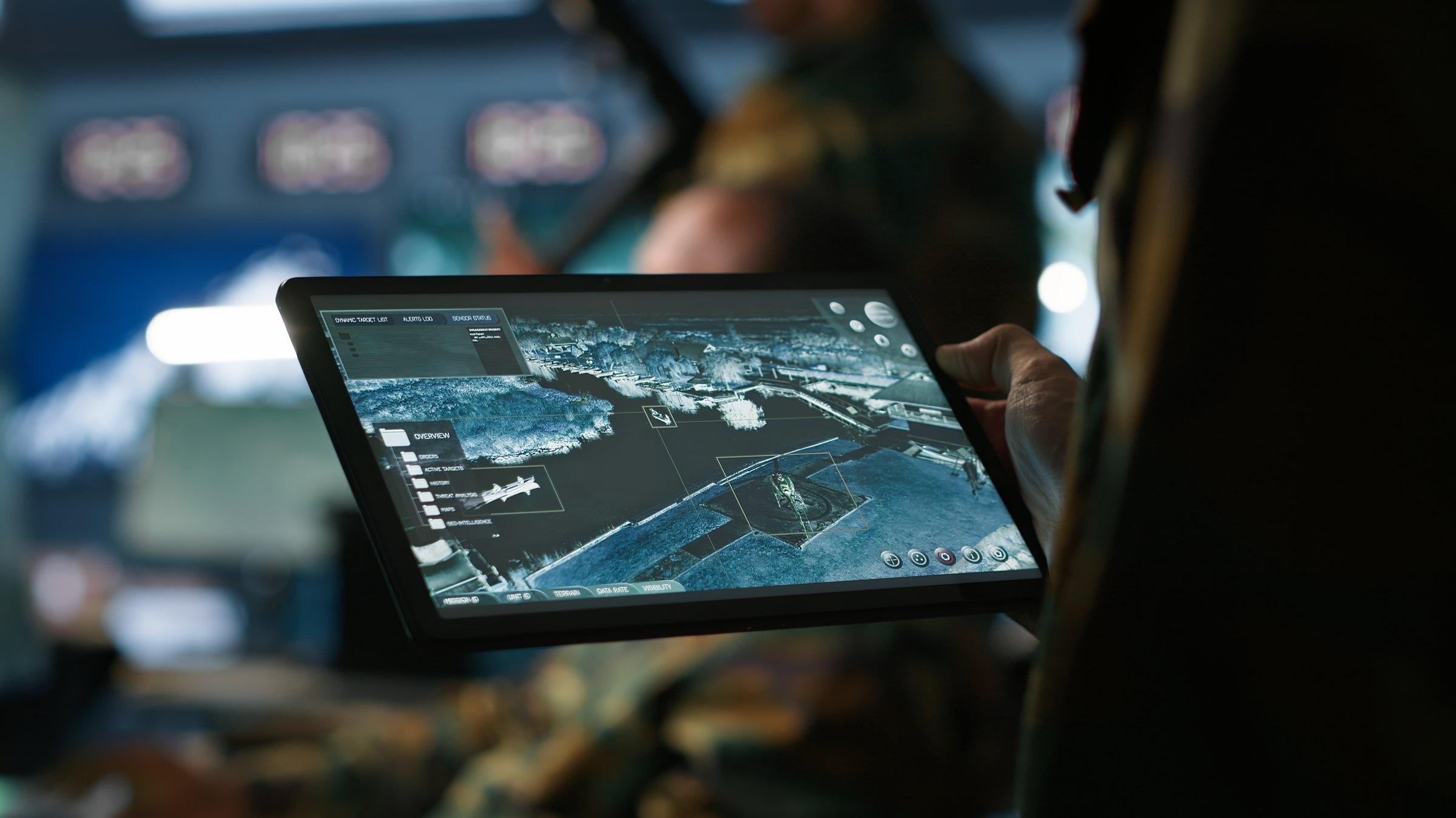 Military agent working in control room, using software on tablet, analyzing aerial reconnaissance data. Close up of intelligence corps expert controlling drones with portable device, camera A