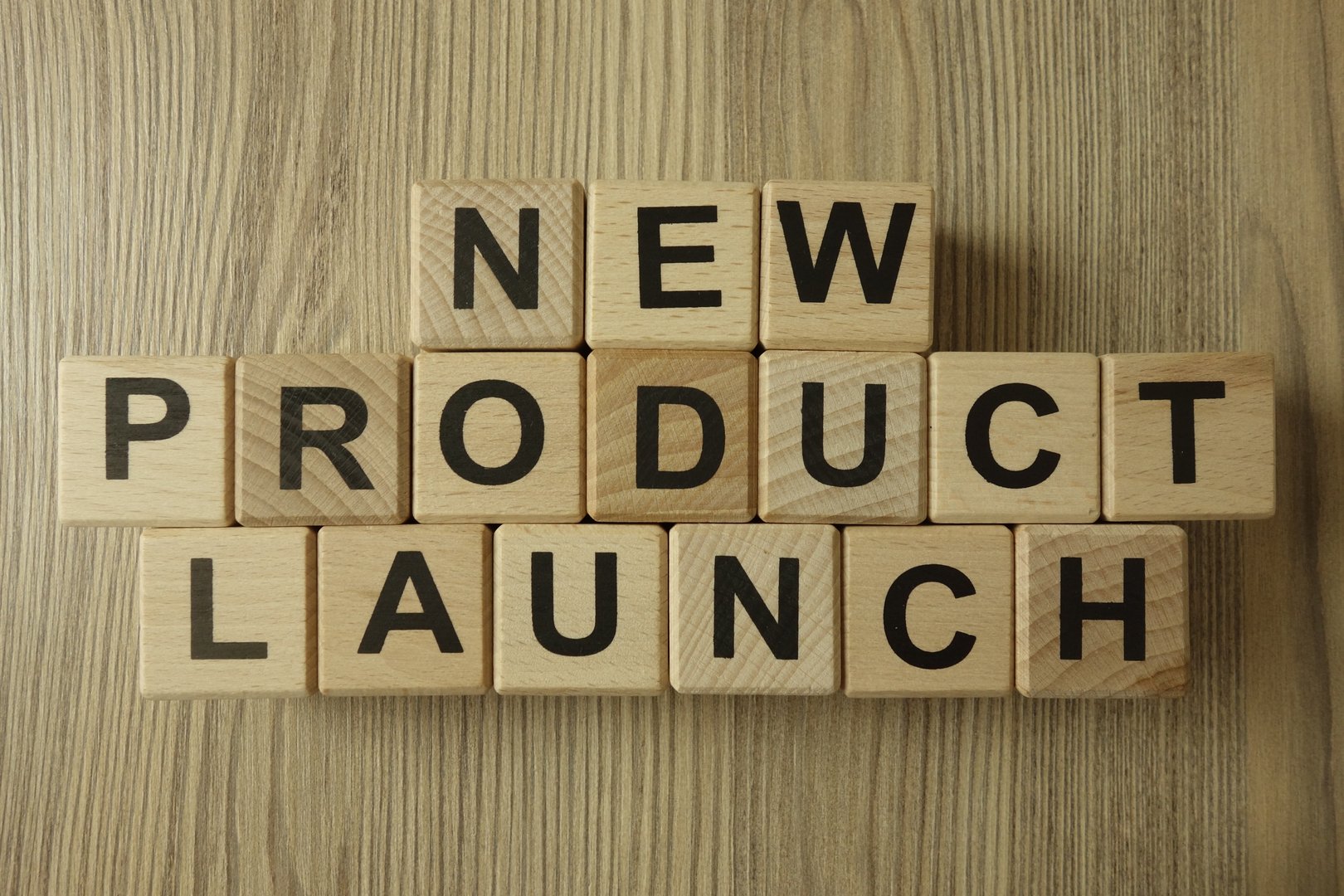 New product launch text from wooden blocks on desk