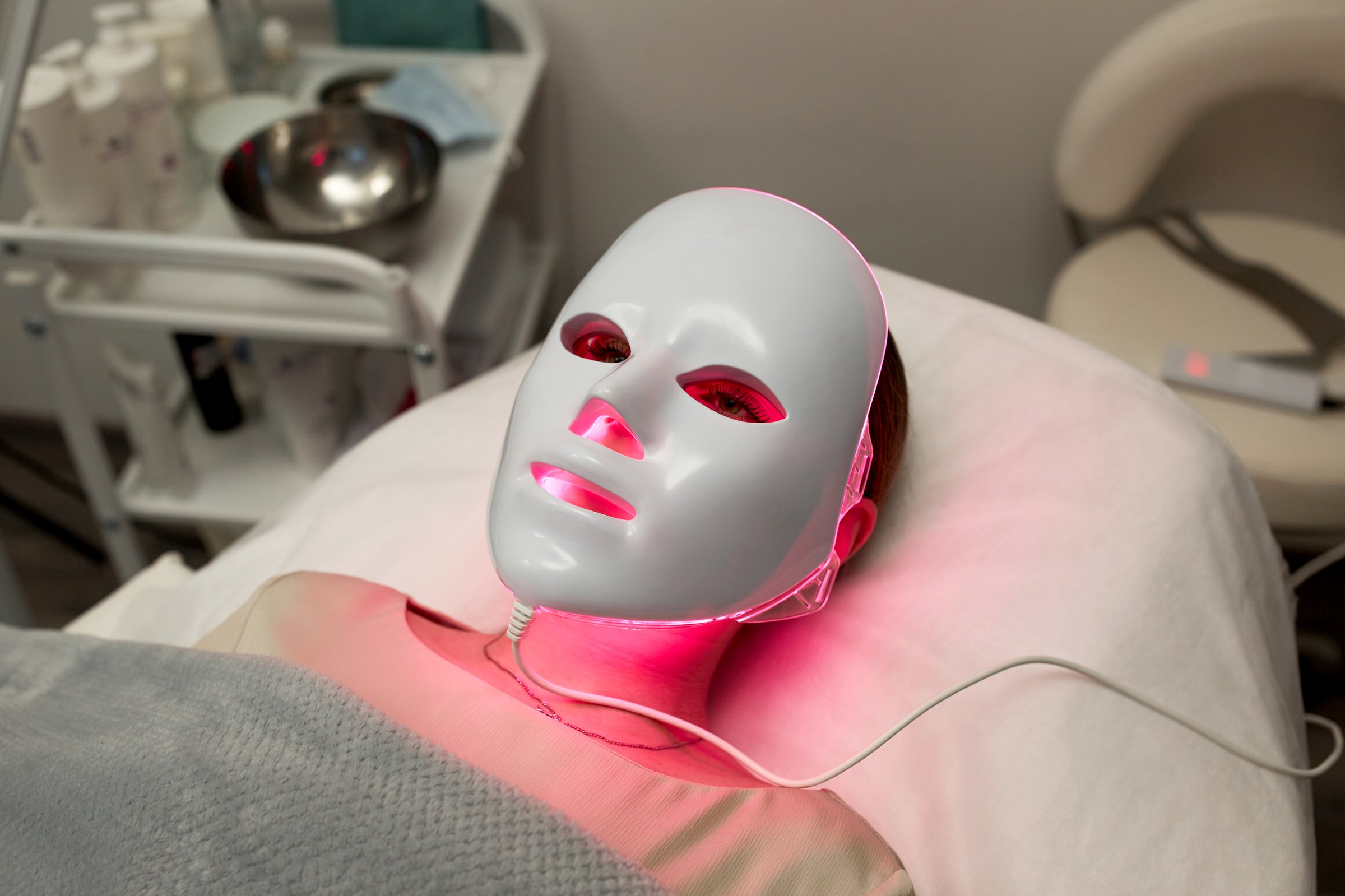 Light rejuvenating mask for facial skin therapy. Photodynamic therapy mask on female face.
