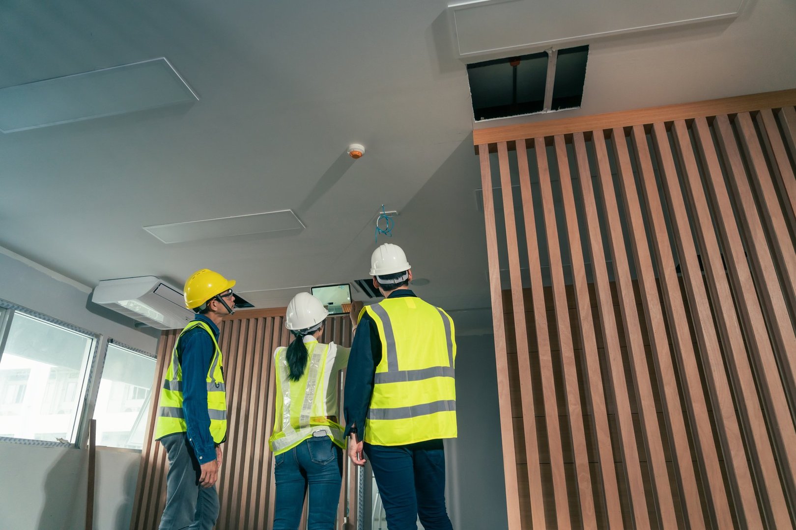 Engineer and architect working discussion plan in construction process interior with augmented reality technology on digital tablet. Concept technology in construction business.