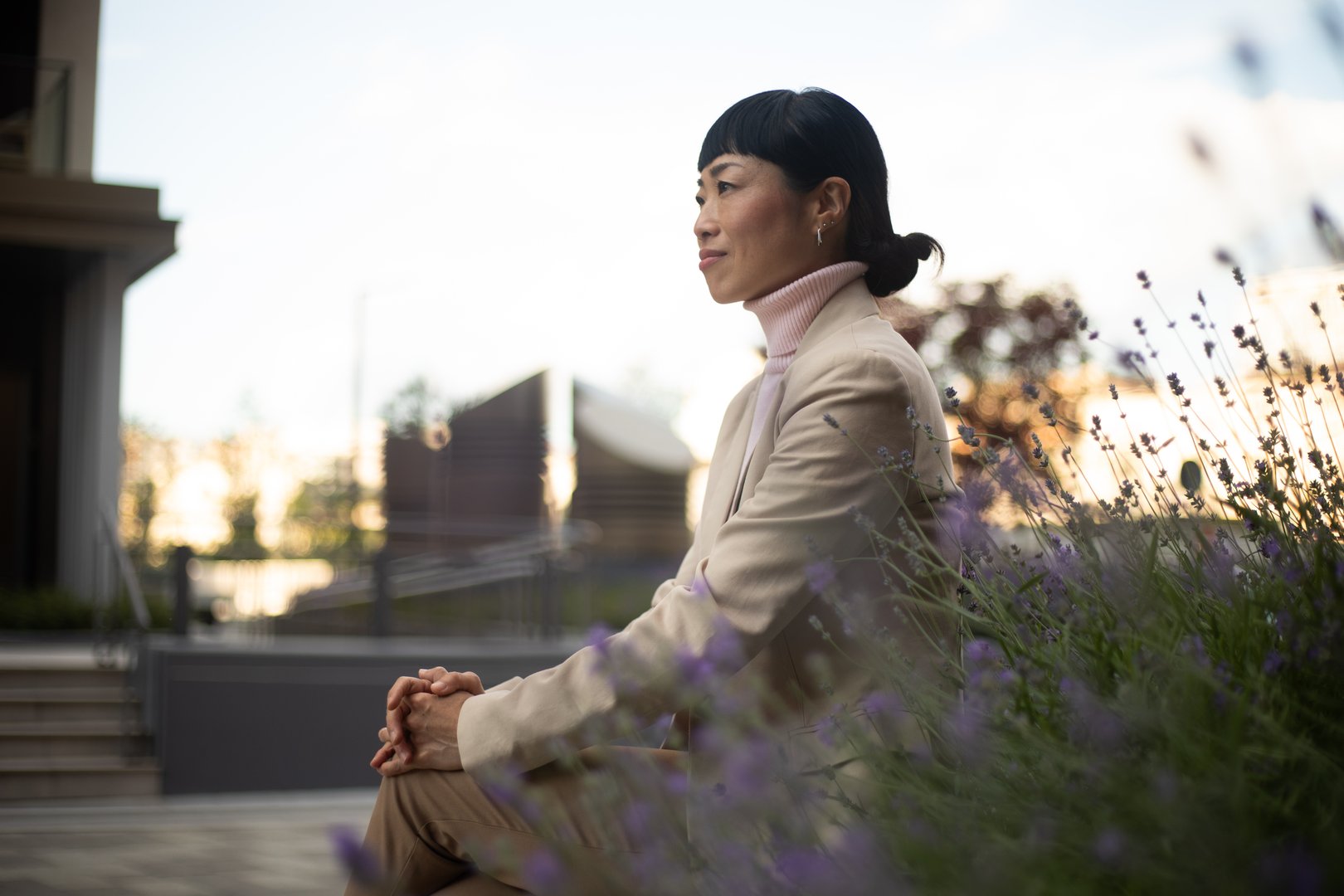 Serene businesswoman taking a break in a peaceful city park, enjoying the tranquil atmosphere