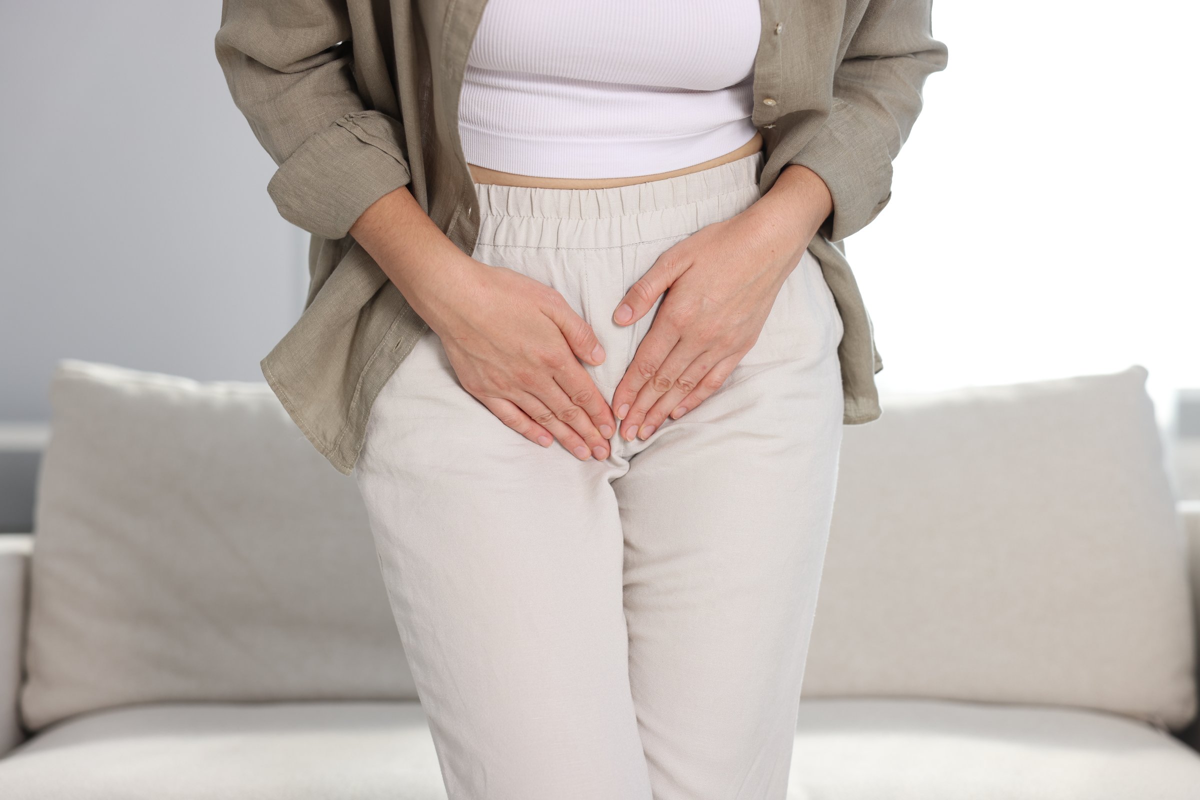 Woman suffering from cystitis symptoms at home, closeup