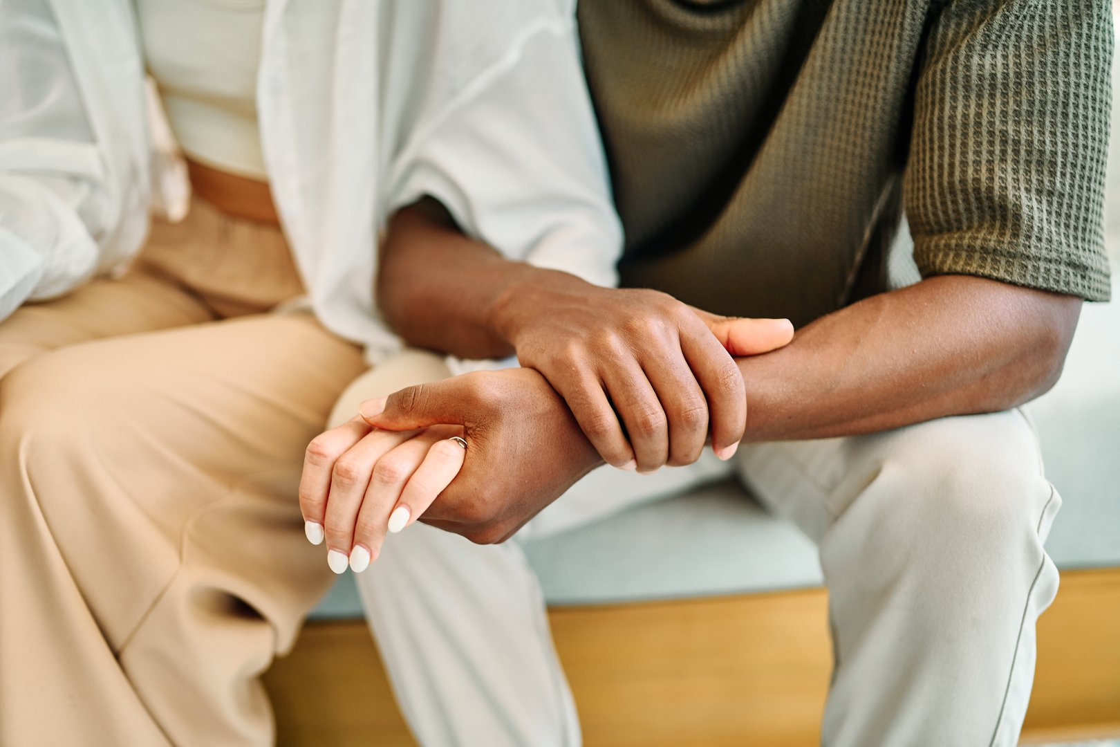 Close up of a young couple hands holding, love concept